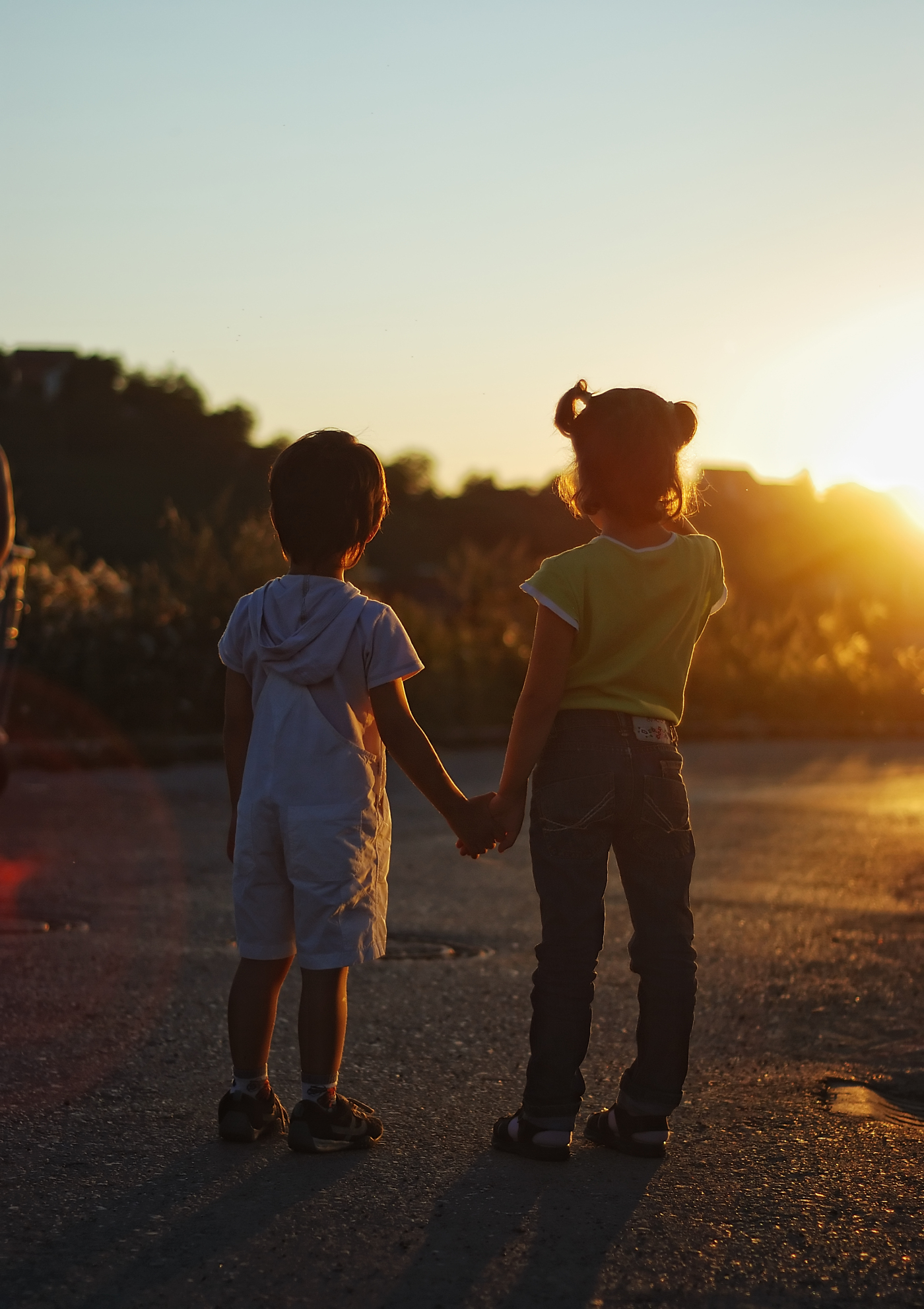 Romantic vision of two children standing together outdoor